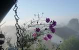 Foto: Dorf im Nebel, darüber blauer Himmel